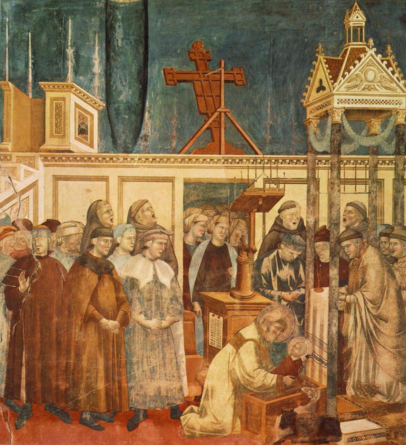 St. Francis kneels before the Christmas crib at Greccio